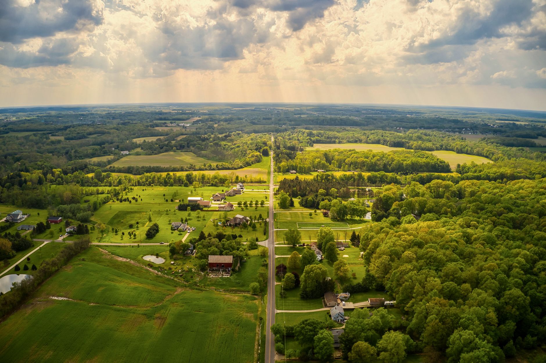 Rural Ohio farmland and open acreage under evening light