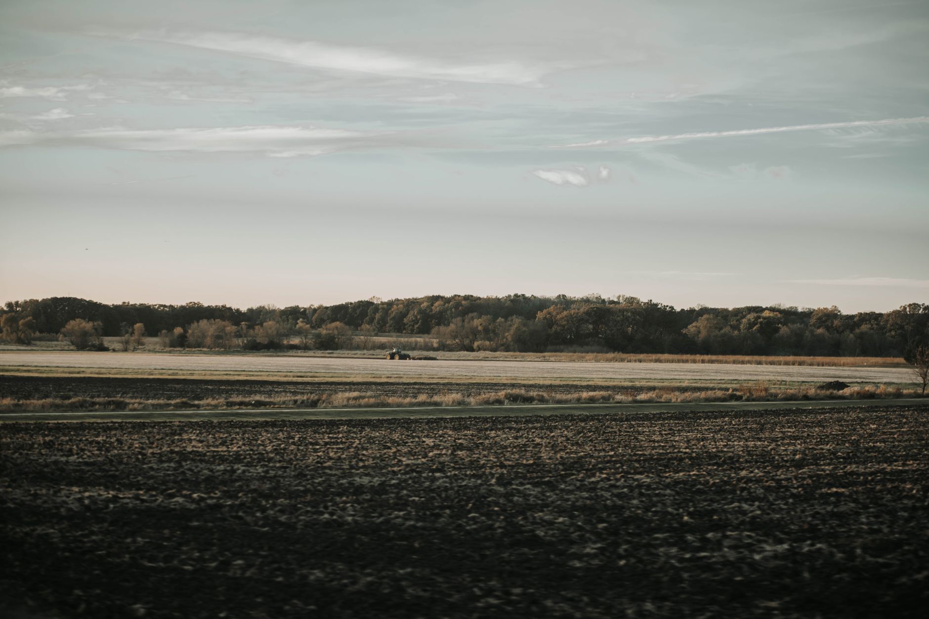 Rural Oklahoma ranchland and cropland along a river valley at golden hour