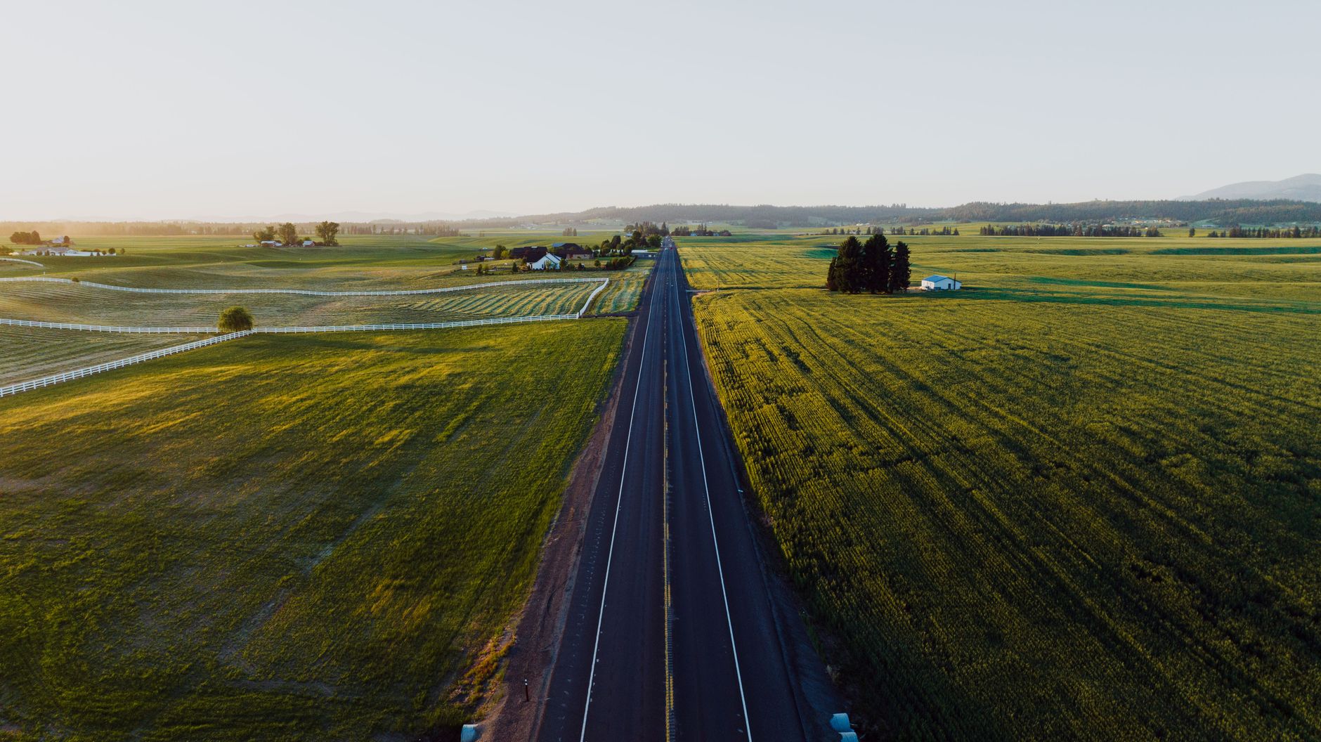 Aerial view of rural Washington state farmland and irrigated cropland at golden hour