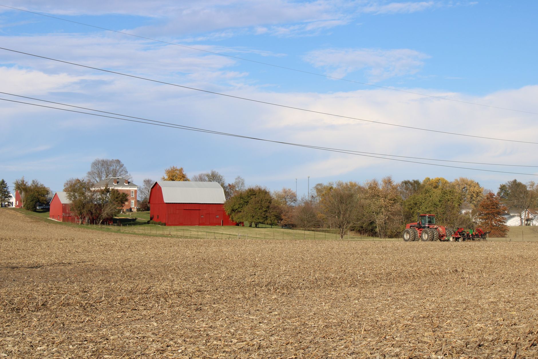 Rural Ohio farmland and open fields, golden hour aerial view.